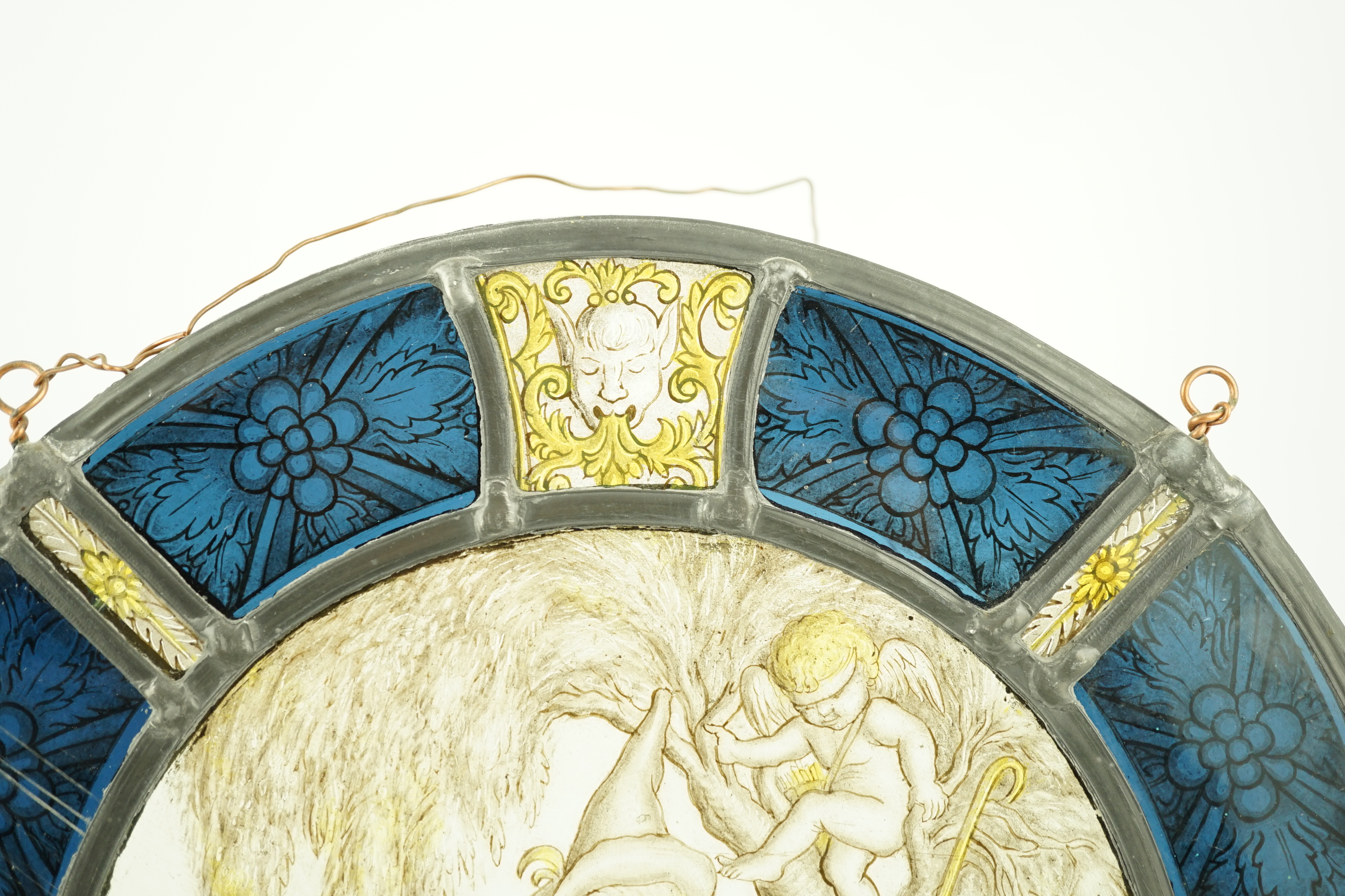 An 18th century Flemish stained glass panel, 32cm diameter